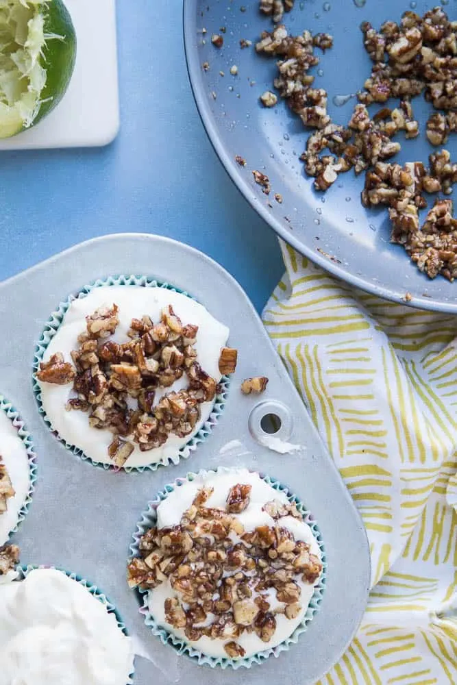 Keto Frozen Key Lime Mini Pies are so easy to make and they can hang out in the freezer and wait until you need them. I love the crumbly candied pecan crust on the bottom! You can make them dairy-free, too. | perrysplate.com 