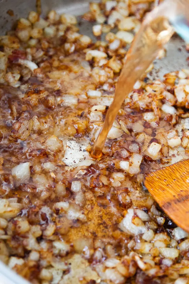 Vinegar-maple mixture poured into the skillet with the onions.