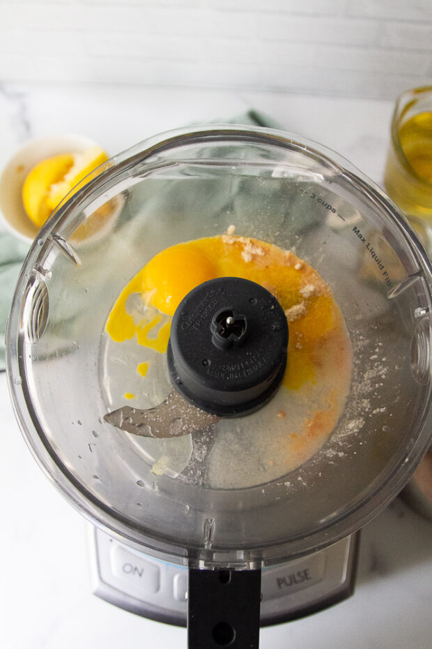 Yolks, ground mustard, and lemon juice in a food processor.