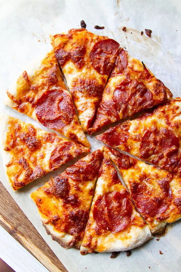 Finished pepperoni pizza cut into slices. 