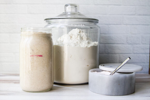 Ingredients for sourdough pizza crust: bubbly sourdough starter, flour, salt, and water (not pictured.)