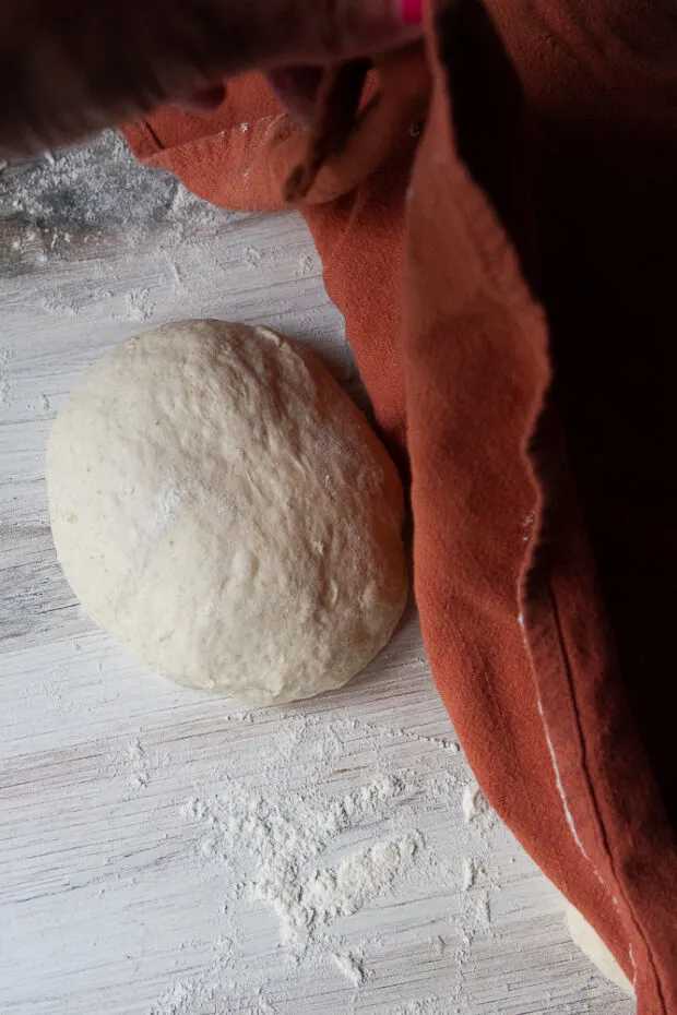 Kitchen towel covering the dough balls.