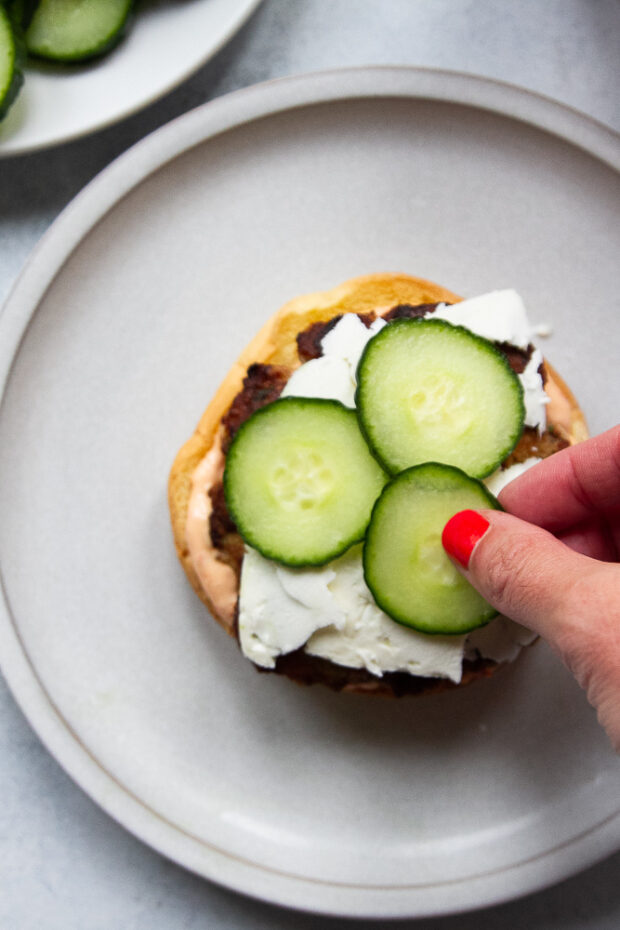 Feta and cucumbers added to a burger.