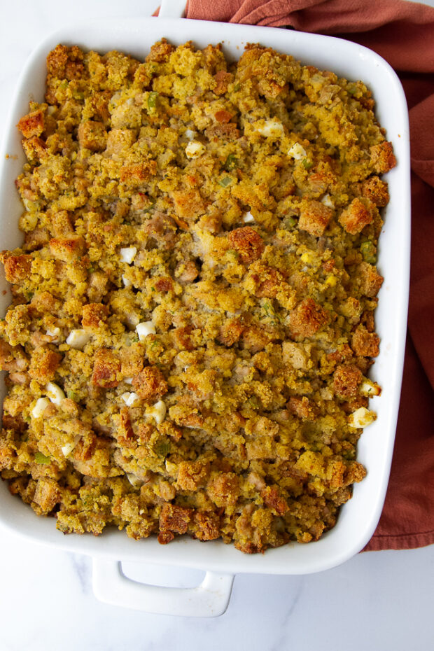 Large white baking dish with finished cornbread dressing.