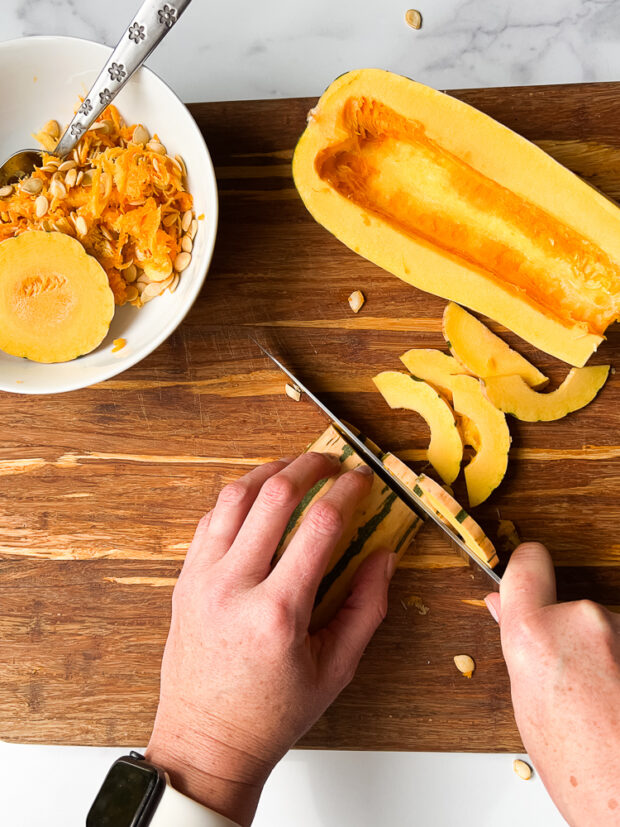 Slicing the squash into thin half-moons.