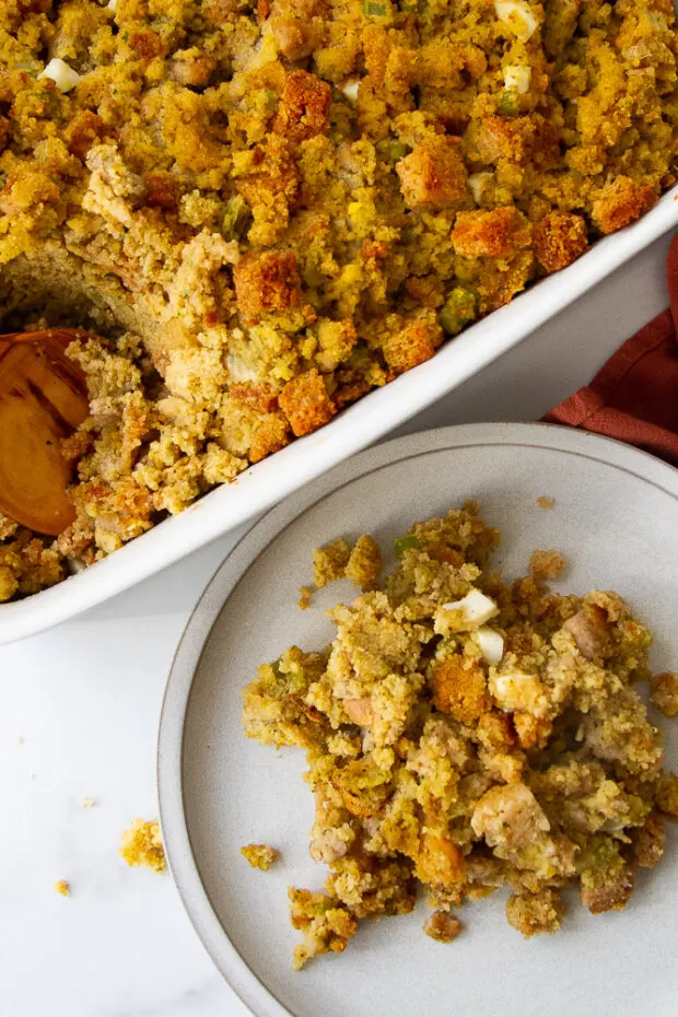 A serving of cornbread dressing out of the baking dish.