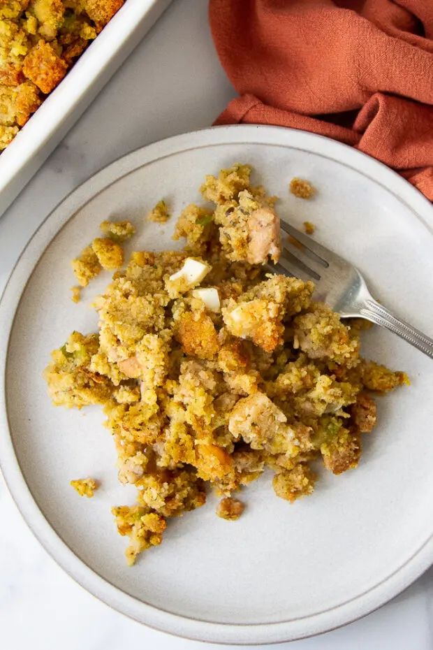 Close up of a serving of cornbread dressing on a plate. 