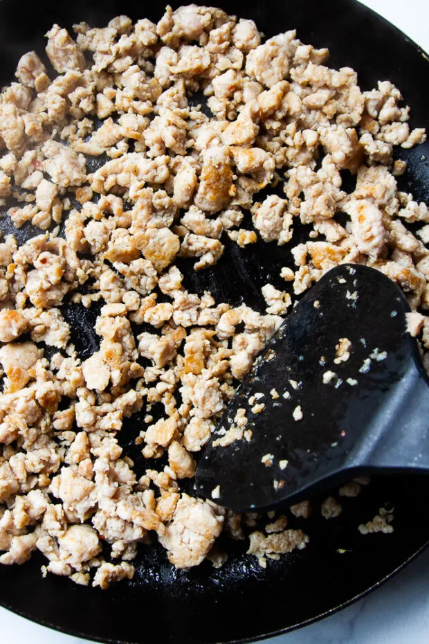 Chicken breakfast sausage browned in a skillet. 