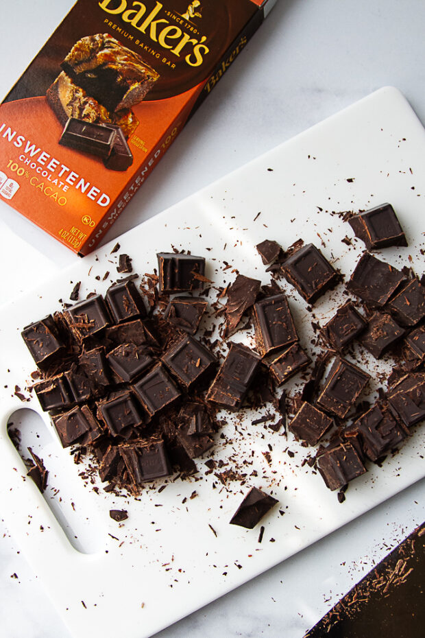 Chopped baking chocolate on a cutting board. 