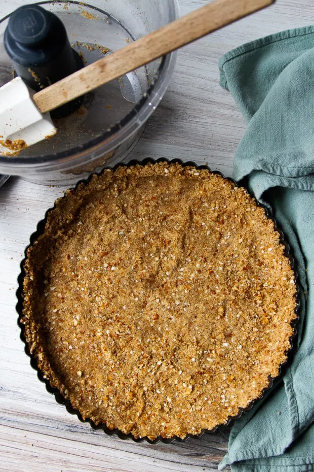 Finished pretzel crust pressed into a tart pan ready for the oven.